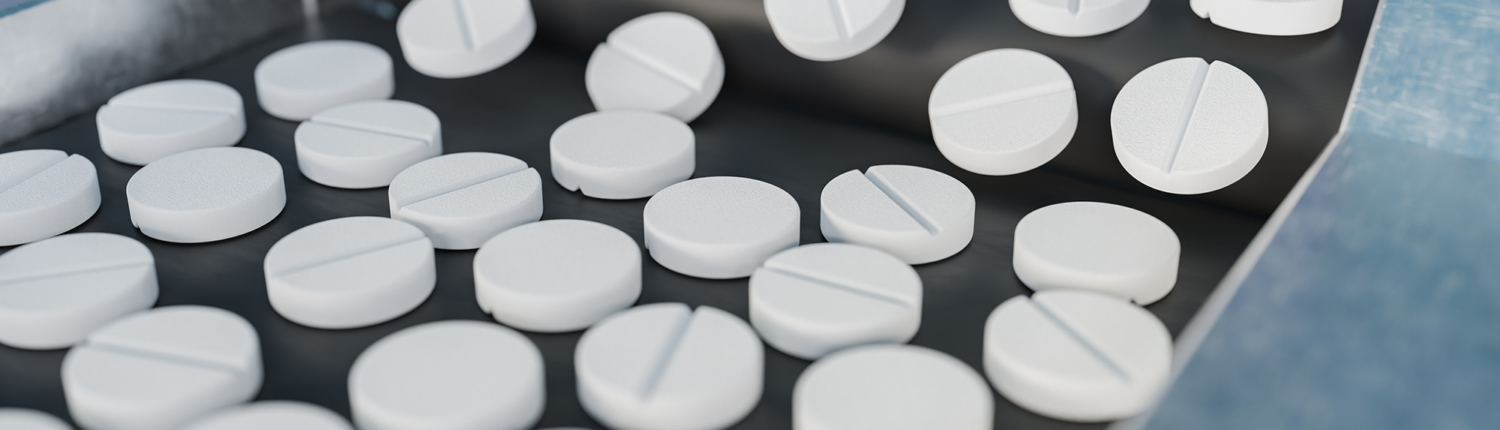 View of uncoated tablets on a conveyor belt