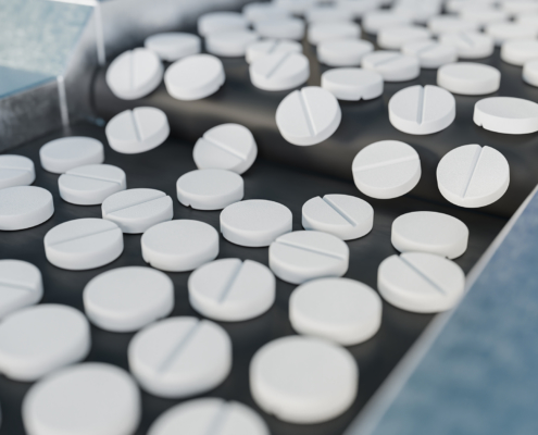 View of uncoated tablets on a conveyor belt