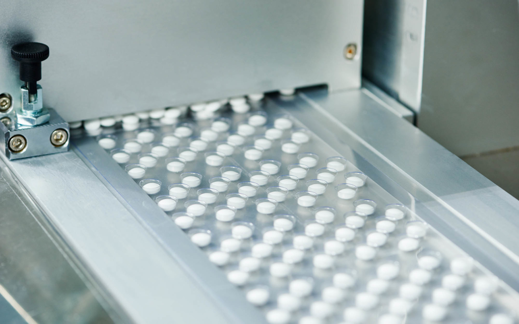 Close up view of tablet uncoated tablets on a conveyor belt